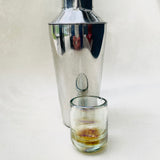 Handblown tequila shot glass with iridescent amber tint.